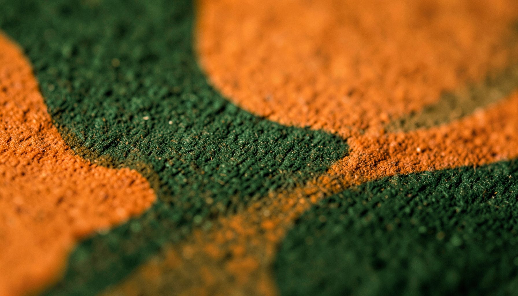 Warm amber and deep forest green abstract texture with soft organic curves, evoking natural earth tones and a calm, grounded atmosphere